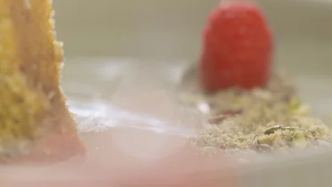 Close-up of raspberries placed next to dessert. Slow motion video Stock Footage 114879366