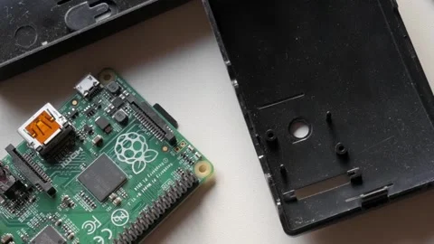 Close-up of Raspberry Pi components inside black case, DIY project on workspace Stock Footage 312197930