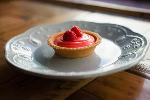 Close up of raspberry tart served in plate on table Stock Photos