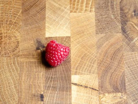 Close-up raspberry on wooden background with copy space. Stock Photos