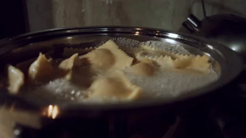 Close-up of ravioli cooking in a pan with boiling water. Preparing ravioli, a Stock Footage 144833720