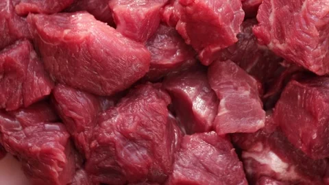 Close-Up of Raw Beef Chunks for Goulash Preparation, Fresh Red Meat Cubes for Stock Footage 310786563