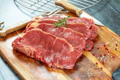 Close up raw beef rib eye on cutting board Stock Photos
