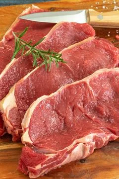 Close up raw beef rib eye on cutting board Stock Photos