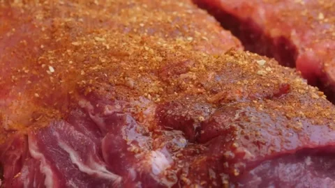 Close-up of Raw Beef Ribeye Steak Seasoned with Barbecue Dry Rub Stock Footage 338212210