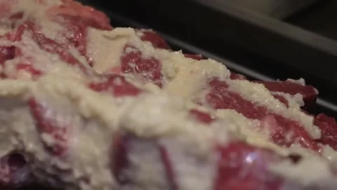 Close-up of Raw Beef Steaks Marinated with Garlic and Butter Herb Spread Video stock 332812736