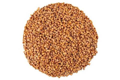 Close-up of raw buckwheat groats in a circular arrangement. Isolated object.. Stock Photos
