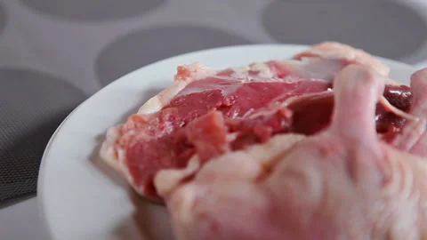 Close up raw chicken leg on rotating plate Stock Footage 130397174