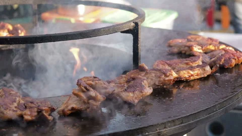 Close-up of raw chicken meat on the round barbecue. Street food. Close-up of the Stock Footage 88269804