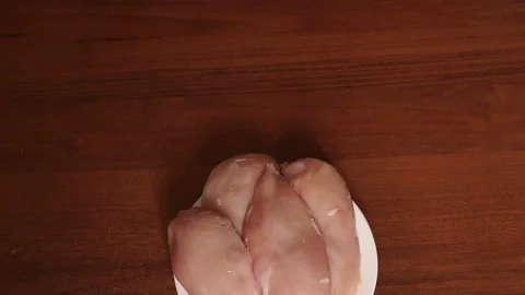 Close-up of raw chicken meat on a white plate. Stock Footage 90366766