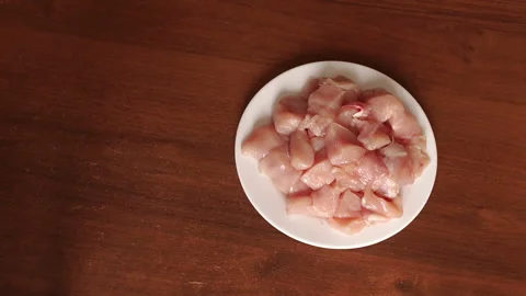 Close-up of raw chicken meat on a white plate. Stock Footage 91637822
