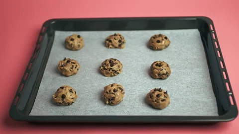 Close-up of raw Chocolate Chip Cookies dough bowls on a cooking sheet. Stock Footage 135703166
