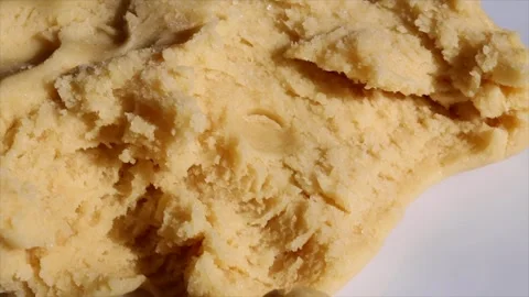 Close-up of raw cookie dough texture on a white surface. Baking ingredients for Stock Footage 303584499