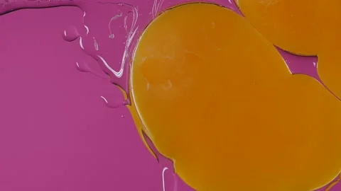 Close up of Raw Eggs Falling on glass in Slow Motion on a pink background Video stock 150356653