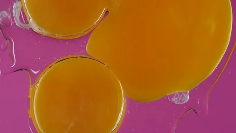 Close up of Raw Eggs Falling on glass in Slow Motion on a pink background Stock Footage 150395711