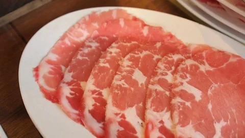 Close-up raw fatty beef, pork meat on white dish for cooking barbecue grilled Stock Footage 83917439