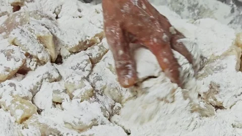Close-up of raw fish pieces heavily coated in white flour. Stock Footage 342517397