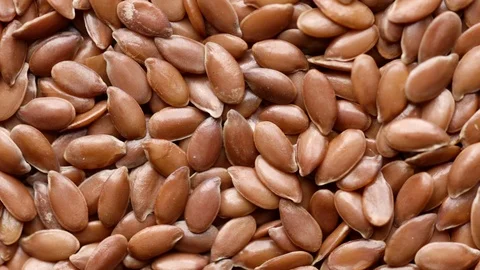 Close up of raw flaxseeds rotating in а circle Stock Footage 119849776