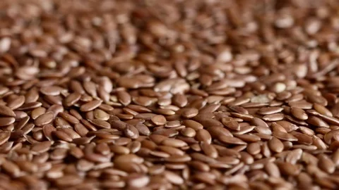 Close up of raw flaxseeds rotating Stock Footage 119872293
