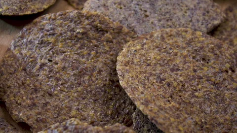 Close-up of raw fruit and seed crackers rotating with shallow depth of field Vídeo Stock 345611151