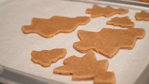 Close up of raw gingerbread cookies are on the baking sheet Stock Footage 99156876