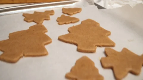 Close up of raw gingerbread cookies are on the baking sheet Stock Footage 99156895