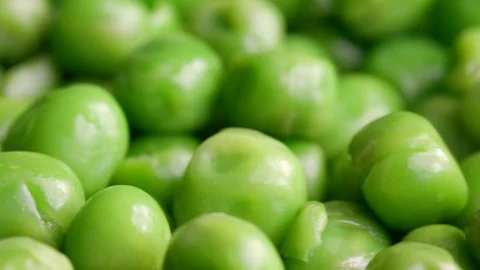 Close up of raw green peas in motion Stock Footage 119896487