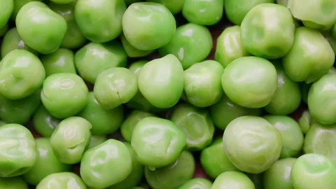 Close up of raw green peas rotating in а circle Stock Footage 119896623
