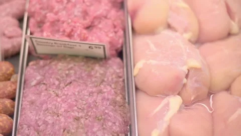 Close-up of raw ground meat and chicken fillets on display in a grocery store Video stock 277617132