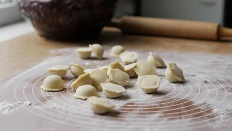 Close-up of raw homemade Russian fresh dumplings crumbling on the table. Freshly Stock Footage 195936635