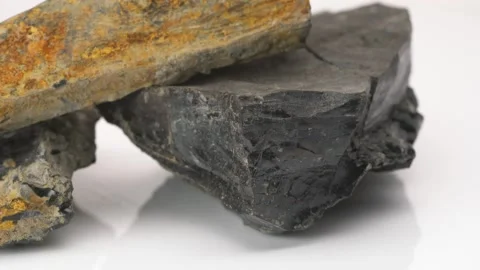 Close up of Raw Jet stone rock rotating on white background Video stock 141608138