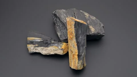 Close up of Raw Jet stone rock rotating on black background Video stock 141608412