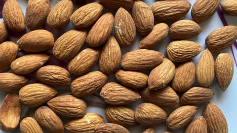 Close-up of raw organic almonds on a white decorative plate Stock Footage 328441259