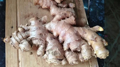 Close-up of Raw Organic Ginger Root on a Wooden Cutting Board Stock Footage 325023070