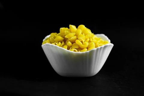 Close-up of Raw Pasta Shells in White Bowl Stock Photos