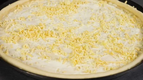 Close up raw pizza cheese is sprinkled on the dough pizza preparation Stock Footage 261120165