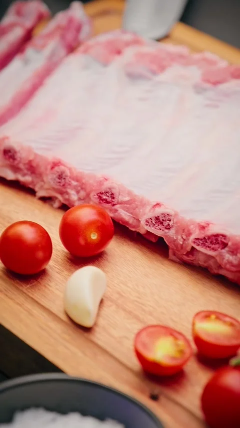 Close-up of raw pork ribs with tomatoes and spices Stock Footage 314606804