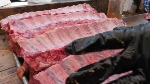 Close-up of Raw Pork Spare Ribs Prepared for Barbecue with Dry Rub Seasoning Видео 338212348