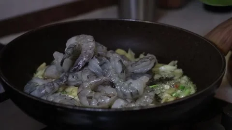 Close Up of Raw Shrimp and Vegetables in Black Frying Pan on Stovetop Stock Footage 298163704