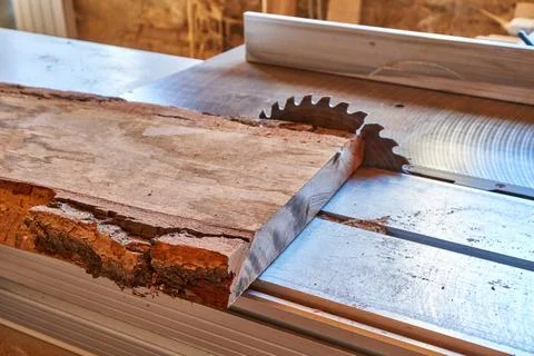 Close-up of raw timber on table saw in a woodworking workshop Stock Photos