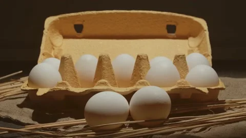 Close up raw white chicken eggs in a cardboard box. 4K video zoom. 動画素材 130884128