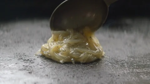 Close up raw whitebait spread onto stove to be cooked Stock Footage 89994346
