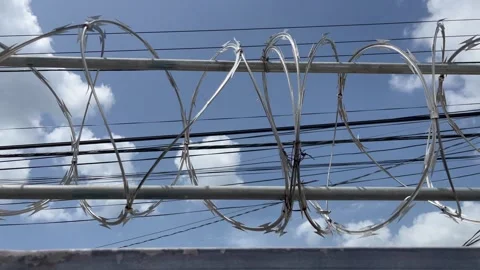 Close up of razor wire above a fence Stock-Footage 265699720