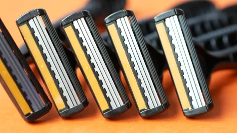 Close up of razors on orange background Stock Footage 214010925