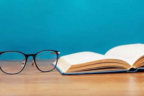 Close-up of reading glasses and opened book Stock Photos