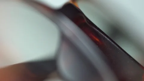 Close up reading glasses light sweep pass isolated extreme close up Stock Footage 119079021