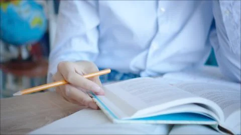 Close up reading textbook in the library 스톡 사진