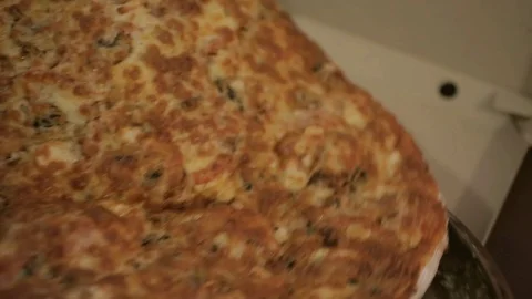 Close-up ready pizza is placed in a cardboard box Stock Footage 100854721