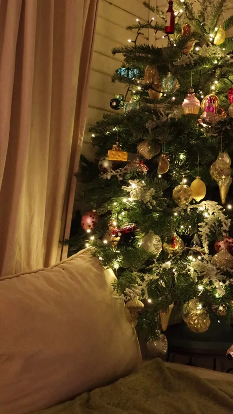 Close-up of a real Christmas tree decorated with glowing garlands and vintage gl Stock Footage 325910251