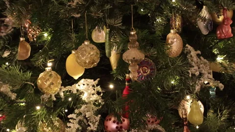 Close-up of a real Christmas tree decorated with glowing garlands and vintage gl Stock Footage 325960496